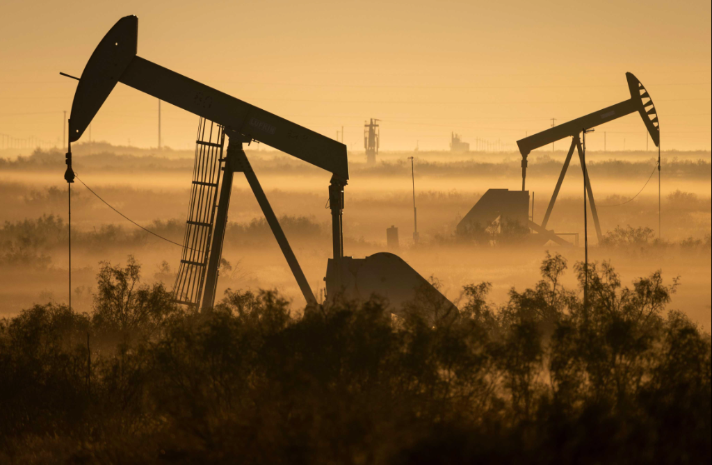 Active pumpjacks in early morning fog